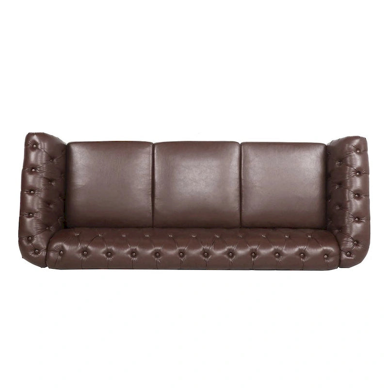 84.65 Divano Chesterfield in finta pelle trapuntata con braccioli arrotolati