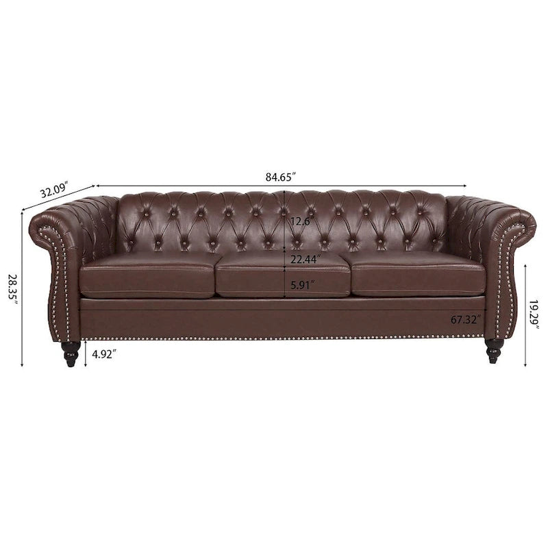 84.65 Divano Chesterfield in finta pelle trapuntata con braccioli arrotolati