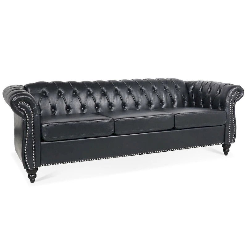 84.65 Divano Chesterfield in finta pelle trapuntata con braccioli arrotolati