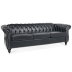 84.65 Divano Chesterfield in finta pelle trapuntata con braccioli arrotolati