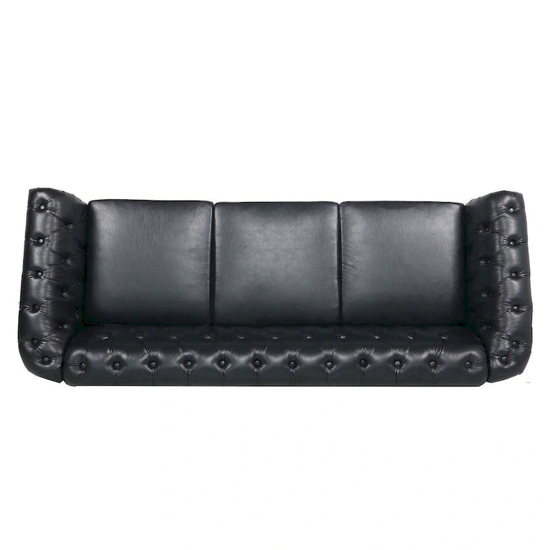 84.65 Divano Chesterfield in finta pelle trapuntata con braccioli arrotolati